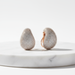 Earrings on marble pedestal